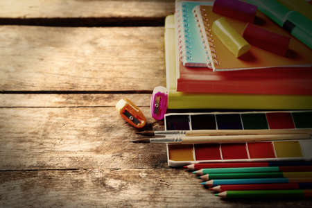 Bright school stationery on old wooden table