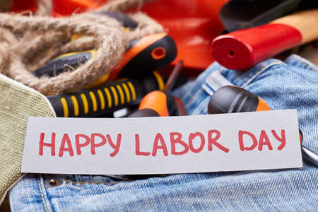 Greeting paper on labor day card and rope on jeans time to celebrate