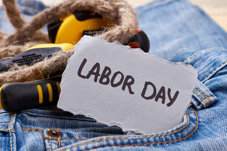 Labor day card near rope tools and paper on jeans relax on holiday