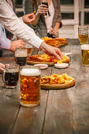 Group of friends enjoying evening drinks with beer Stock Photo