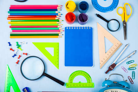 Back to school items for the school on a blue wooden table