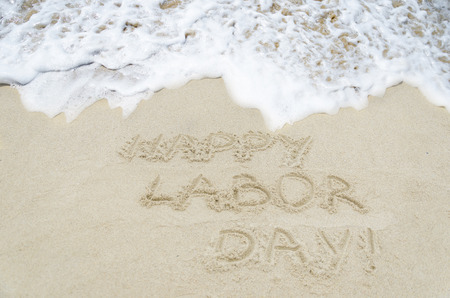 Labor day background on the sandy beach near ocean