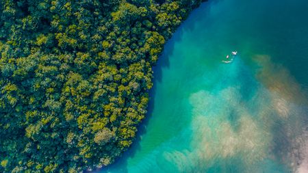 Aerial view of a beautiful ocean and white sandy beach at bukit keluang terengganu malaysia from a drone